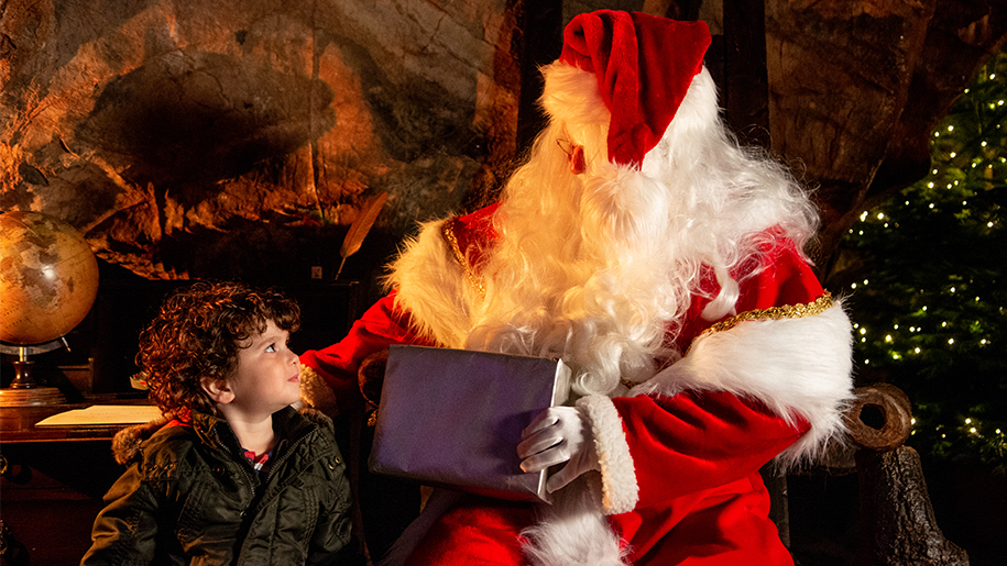 A child meeting Father Christmas at Cheddar Gorge & Caves.