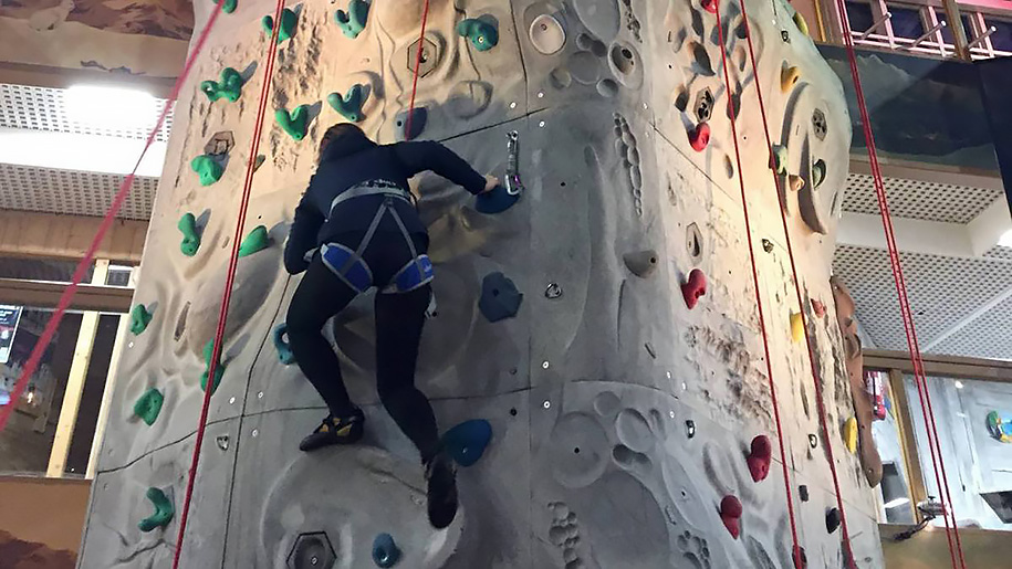 boy on rock climbing wall