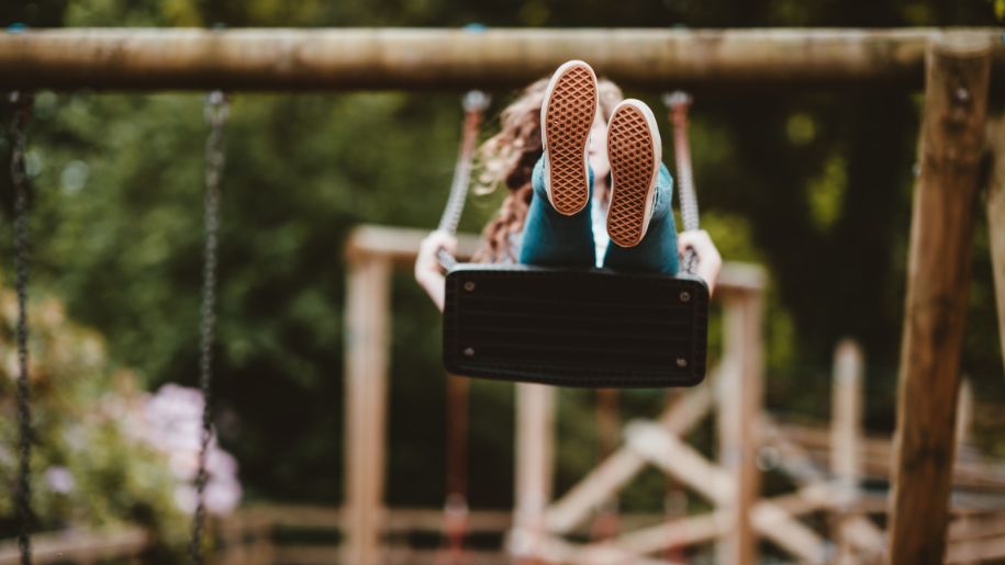 Child on a swing in a park