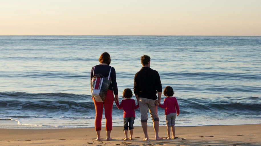 Two adults and two children by the sea.