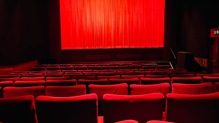 Red seats in an auditorium.