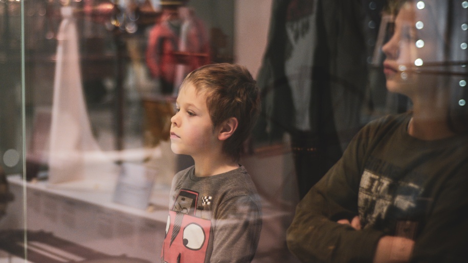 Child staring at museum exhibit.