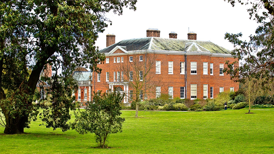 view of manor house through trees