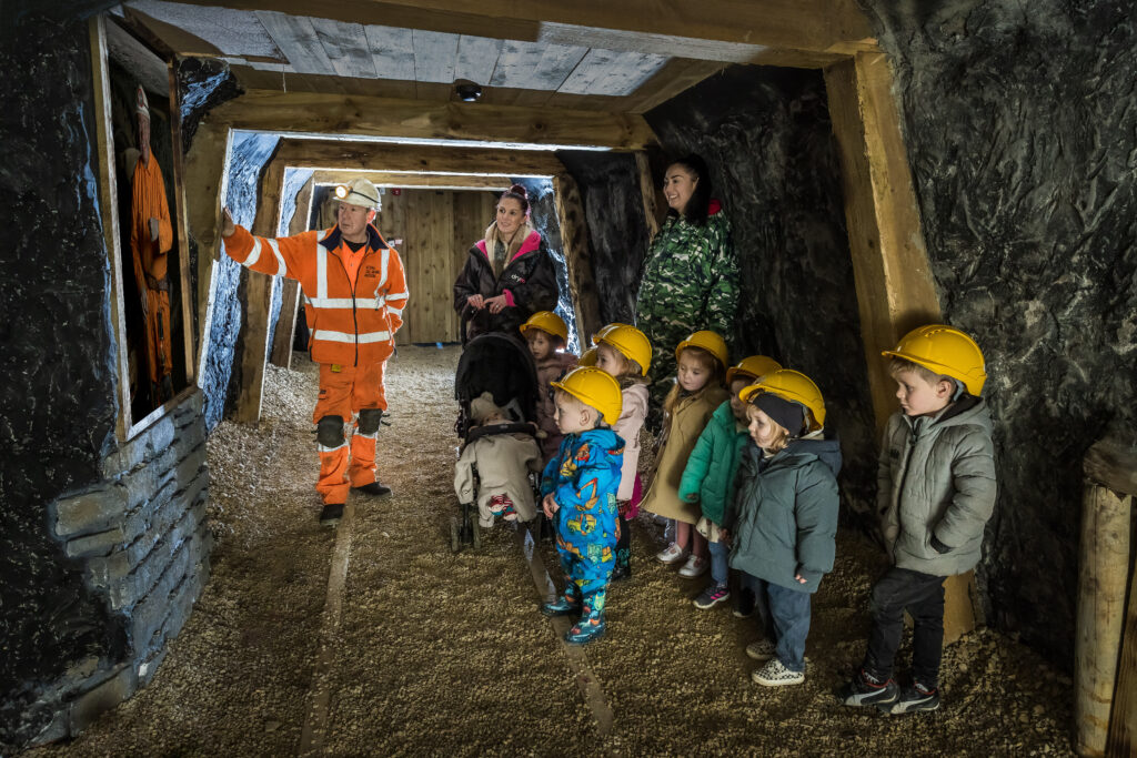 family in coal mine with tour guide