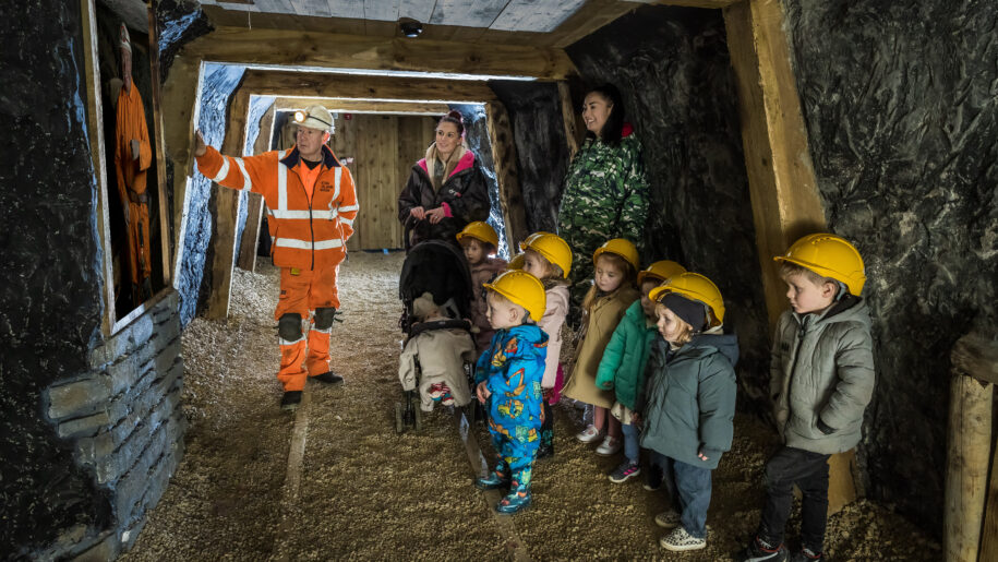 family in coal mine with tour guide