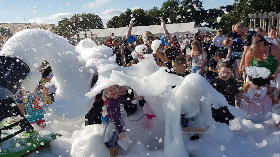 families covered in foam bubbles on a summers day