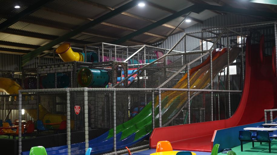 indoor soft play with coloured slides and metal cages