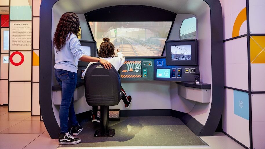 Mother and child looking at interactive screen at London Transport Museum