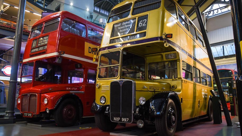 A red and a yellow bus at London Transport Museum