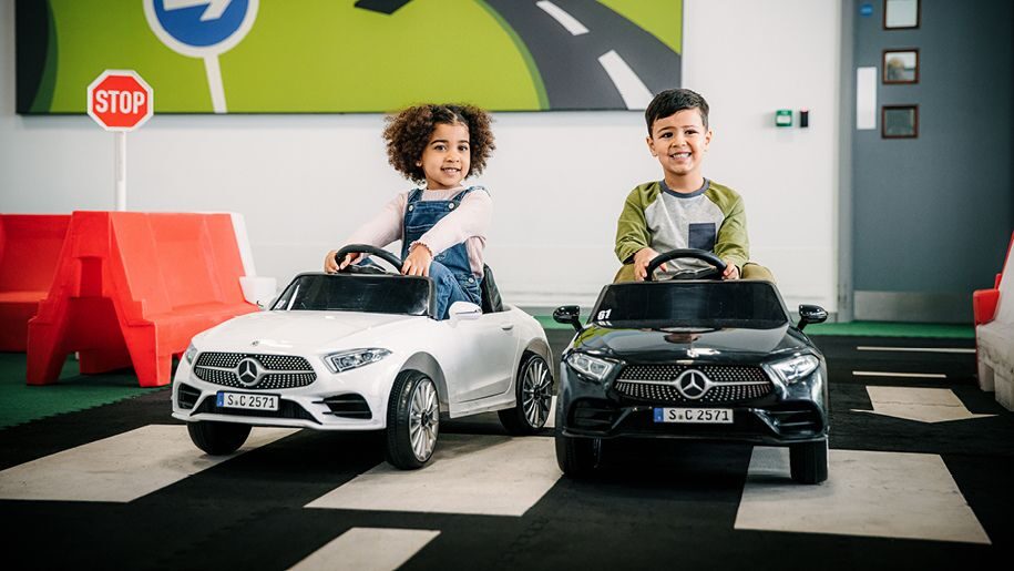 Kids playing in toy cars at Mercedes-Benz World