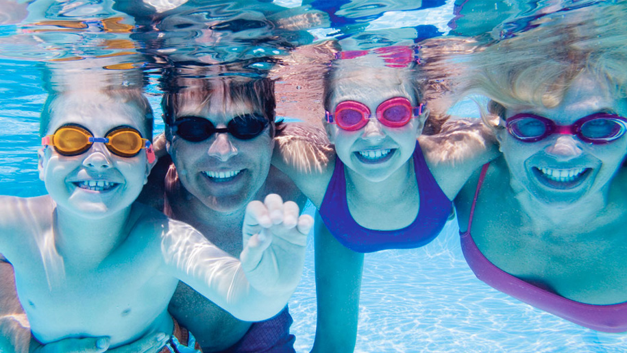 family swimming underwater
