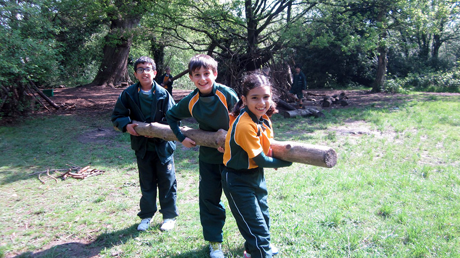 children carrying a log