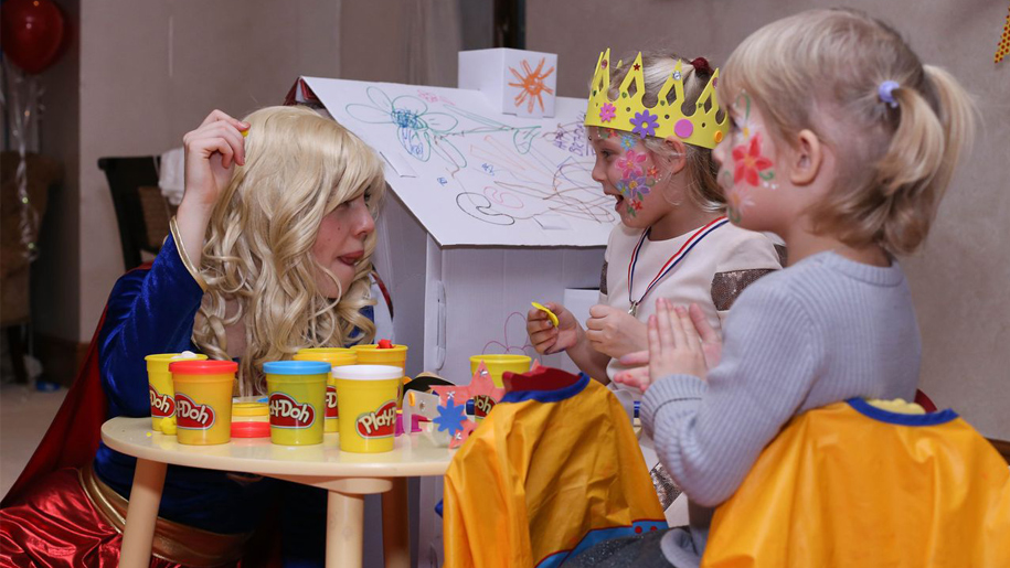 children in dressing up with play doh