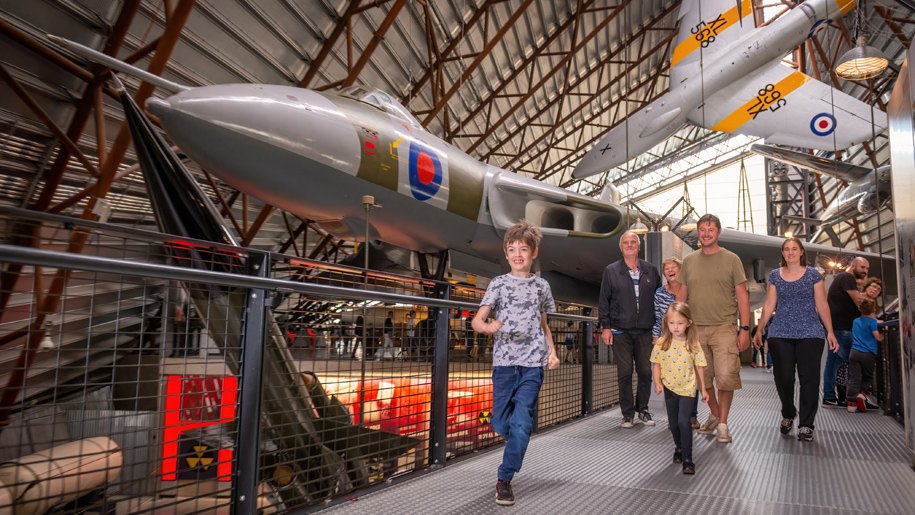 Families exploring the hangars at the Royal Air Force Museum Midlands.