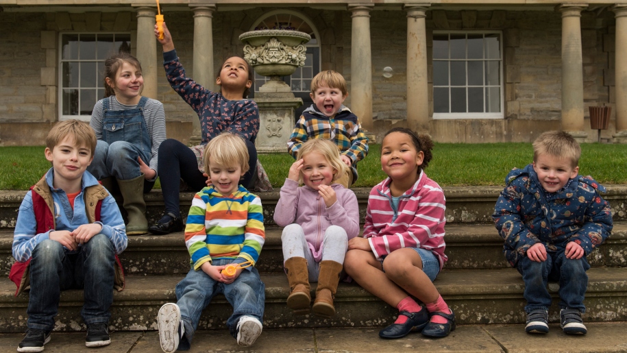 children sitting on steps outside Ragley Hall