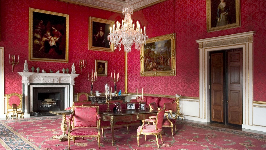 Red room with chairs and paintings