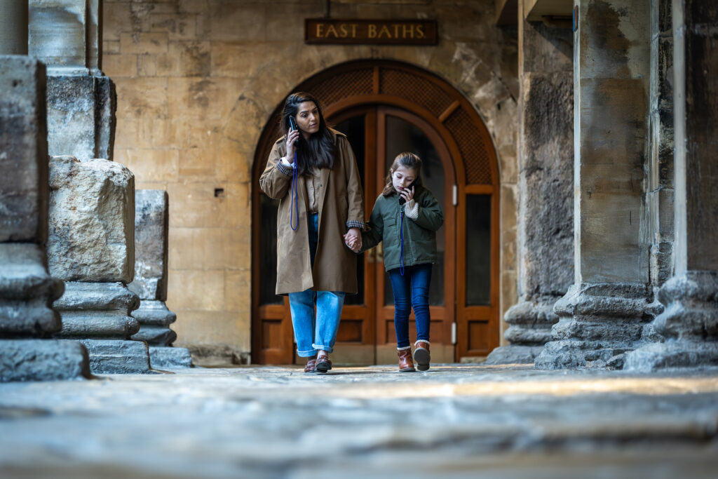 mother and child walk round roman baths