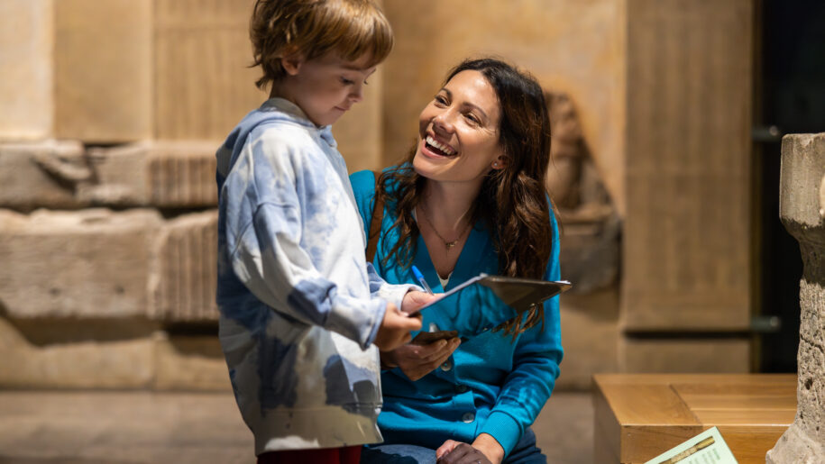 mother and boy stand in museum