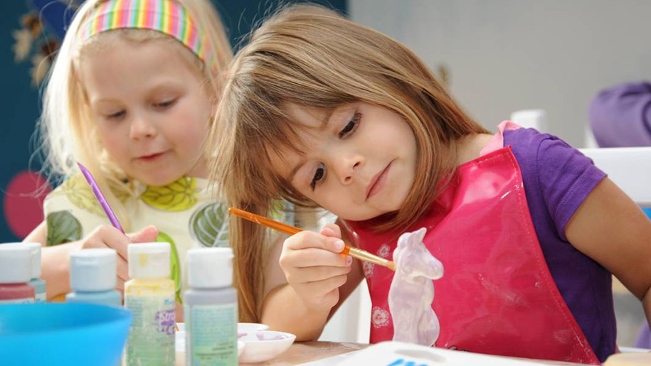 girl painting ceramic horse