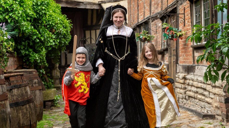 Woman and two children in historical costume at Tudor World