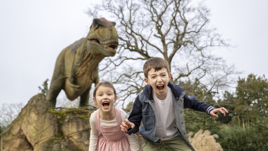 Dinosaur and children at West Midlands Safari Park.