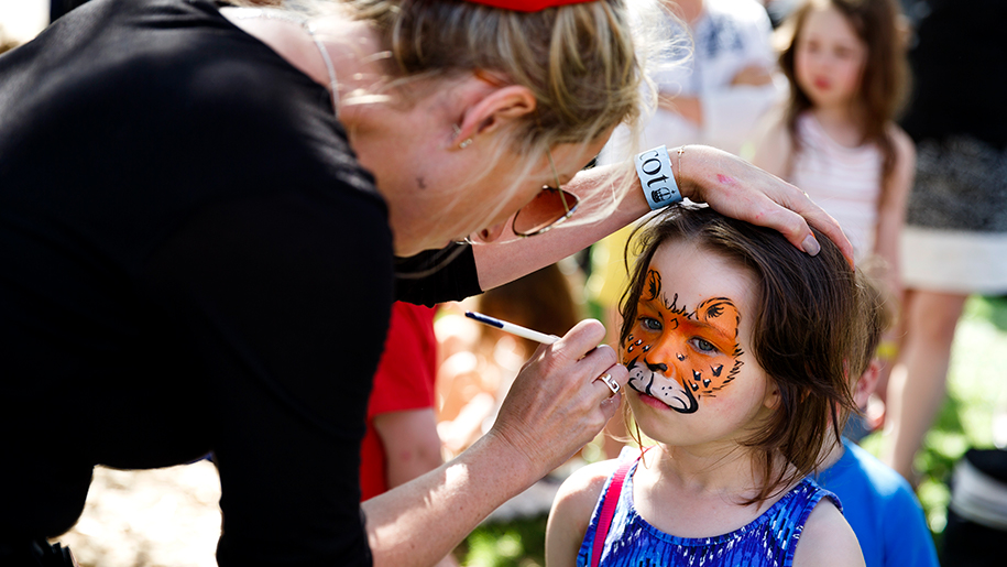 Face painting at a family race day at Ascot Racecourse in Berkshire.