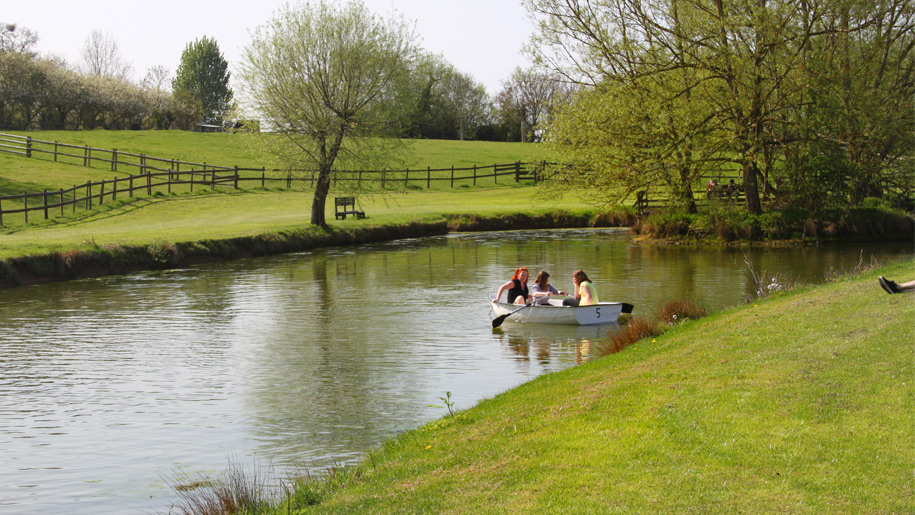 Visitors in a rowing boat at Avon Valley in Somerset.