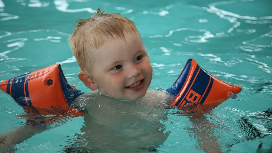 young child swimming