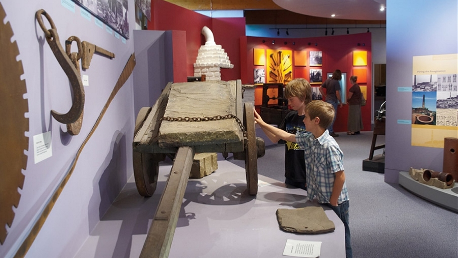 boys touching museum artefact
