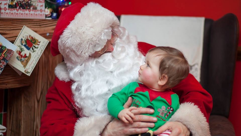 Father Christmas and child dressed as elf