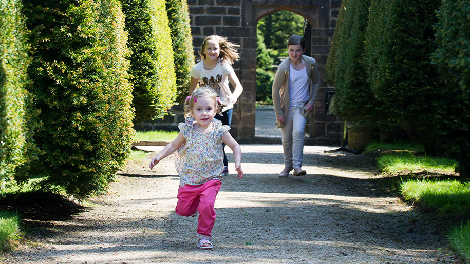 children running through gardens