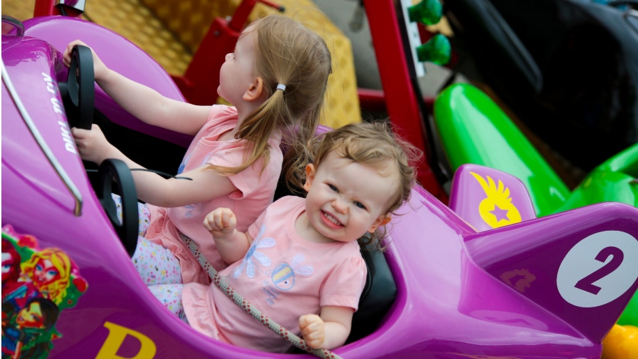 girls in toy car