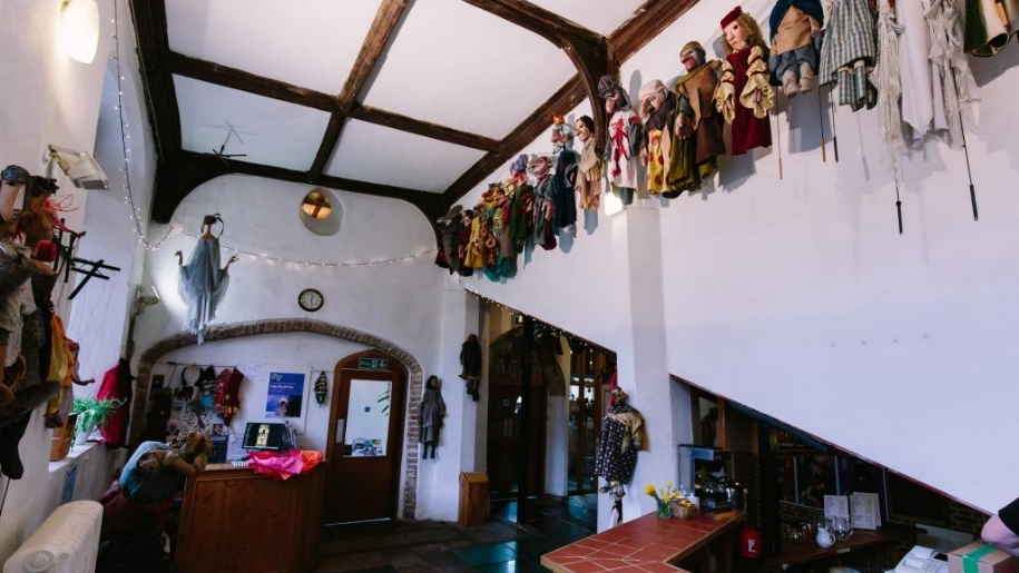 foyer with puppets on walls