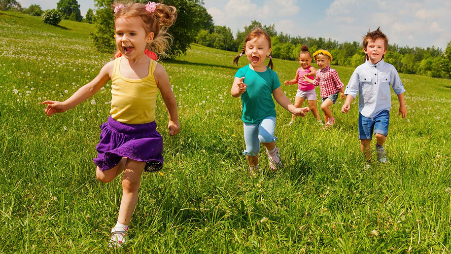 children running through grass