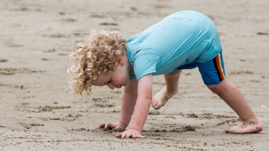 child playing on beach