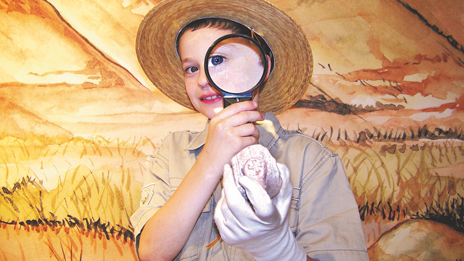 boy holding magnifying glass