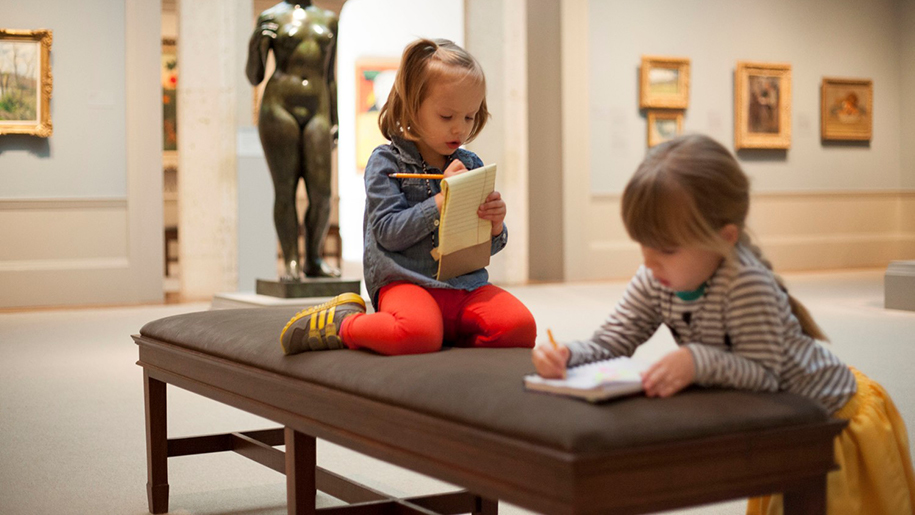 children writing in museum