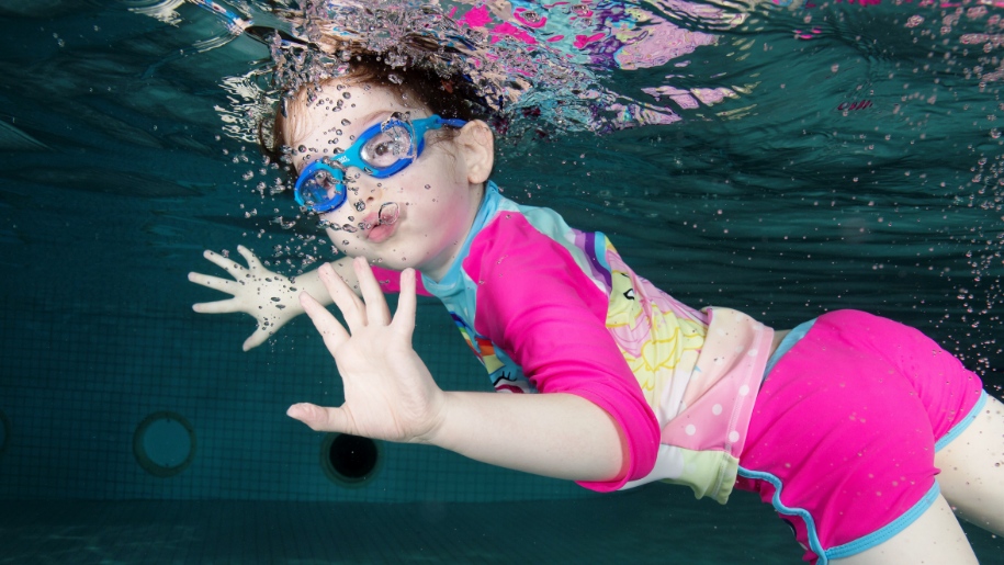 girl swimming under water