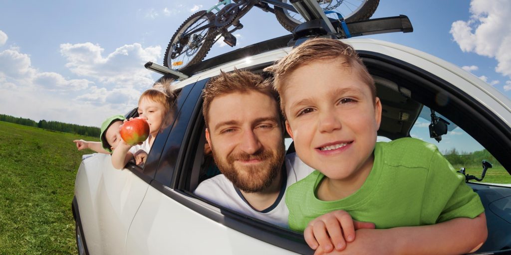 dad and kids in car ready to travel