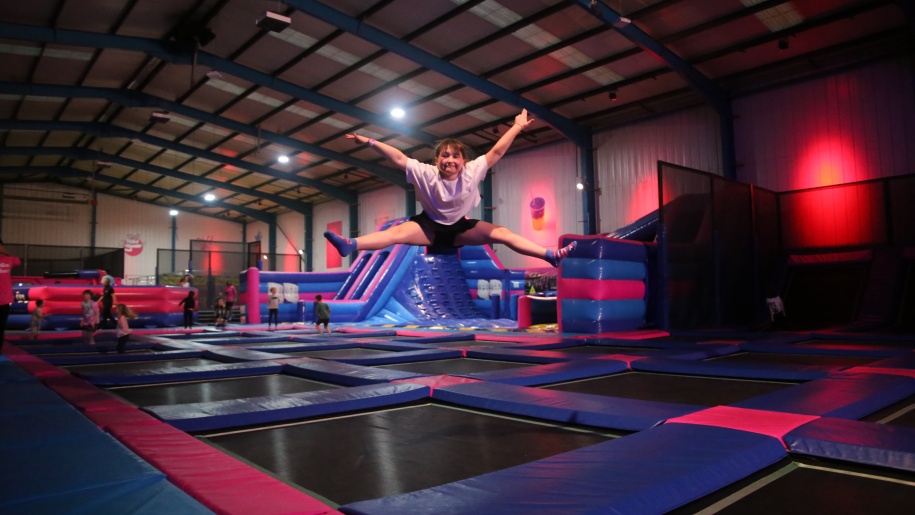 Visitor bouncing on interconnected trampolines.