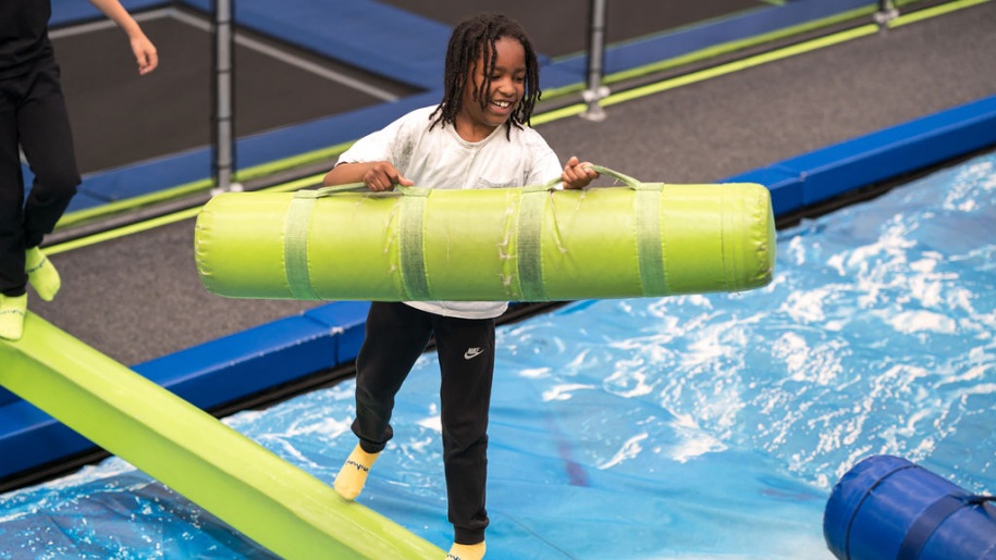Child on a battle beam at Jump In.