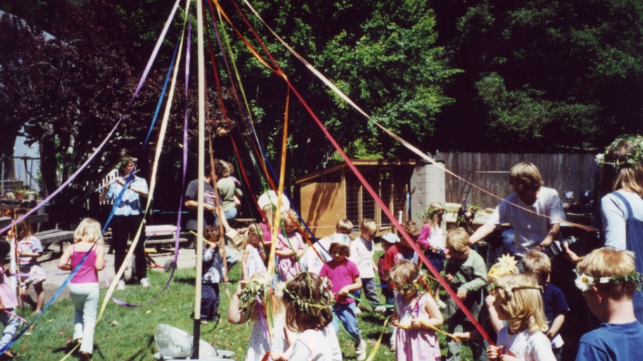 kids dancing around May Pole
