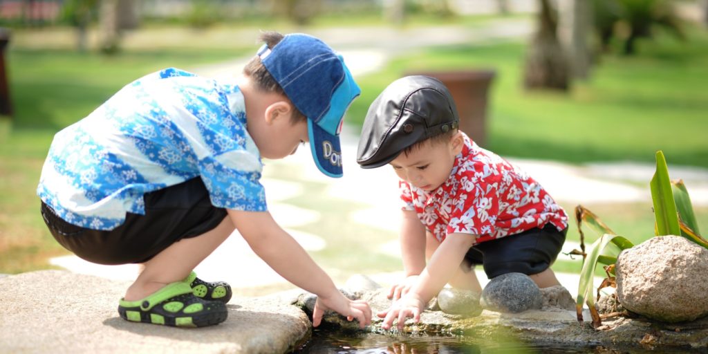 two boys looking in pond