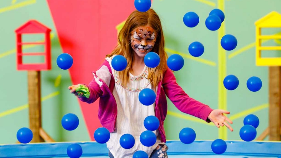 child playing in ball pit