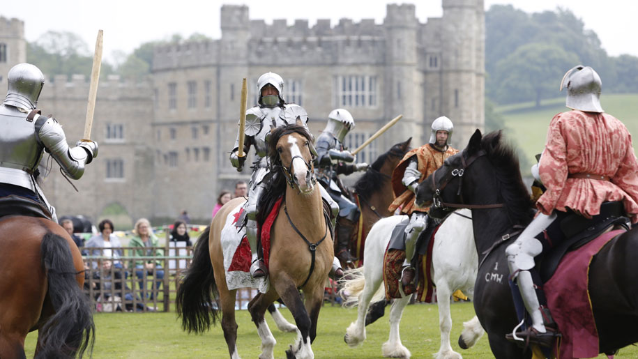 knights on horses in front of castle