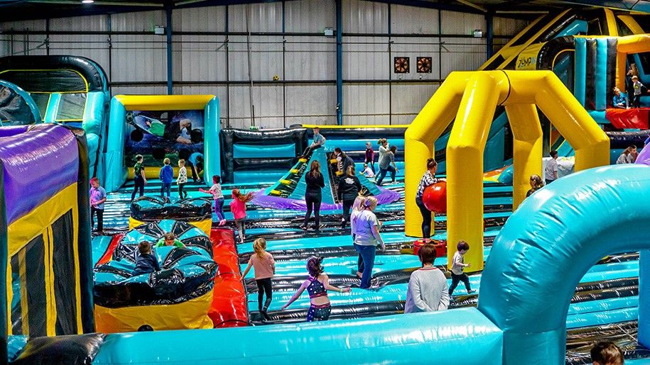 kids bouncing on huge inflatable castle