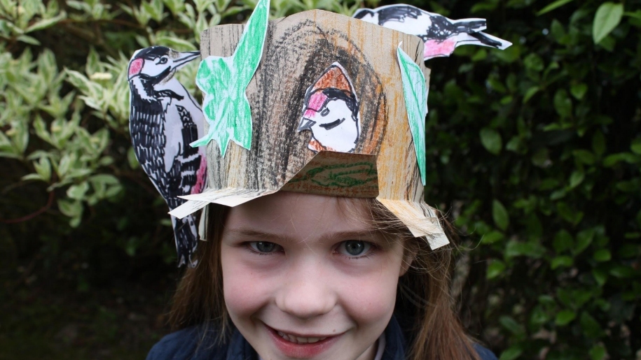 girl with paper hat of animals on her head