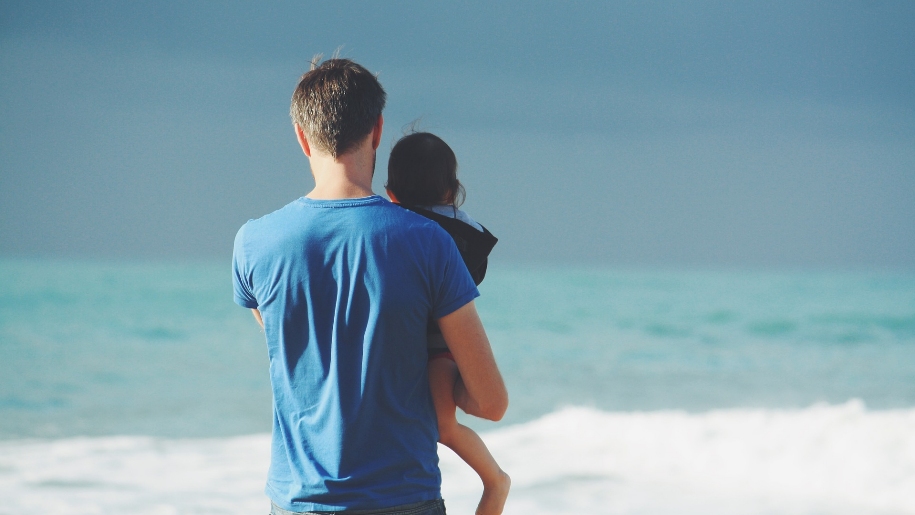 father and child on beach