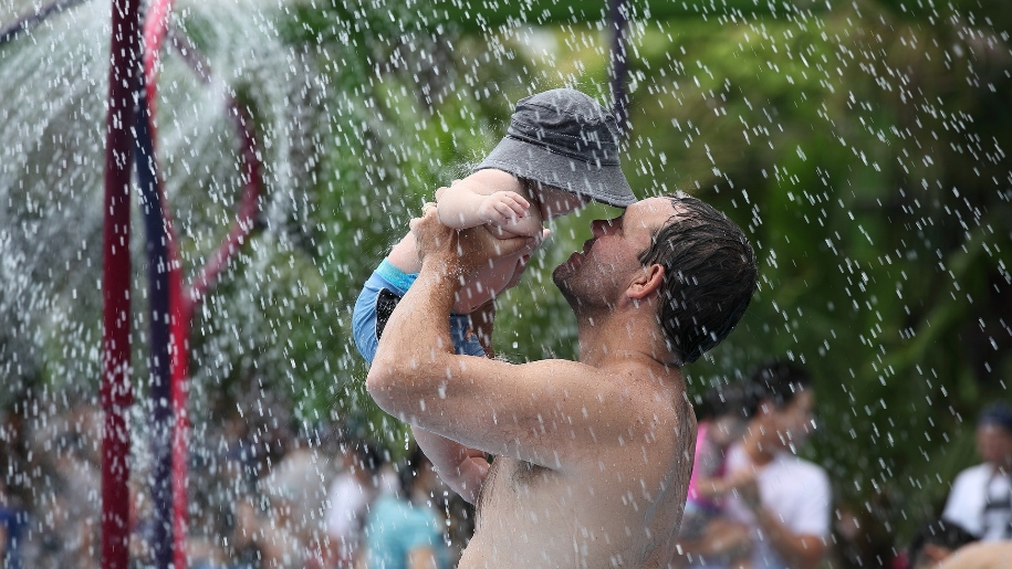 father and child in splash park