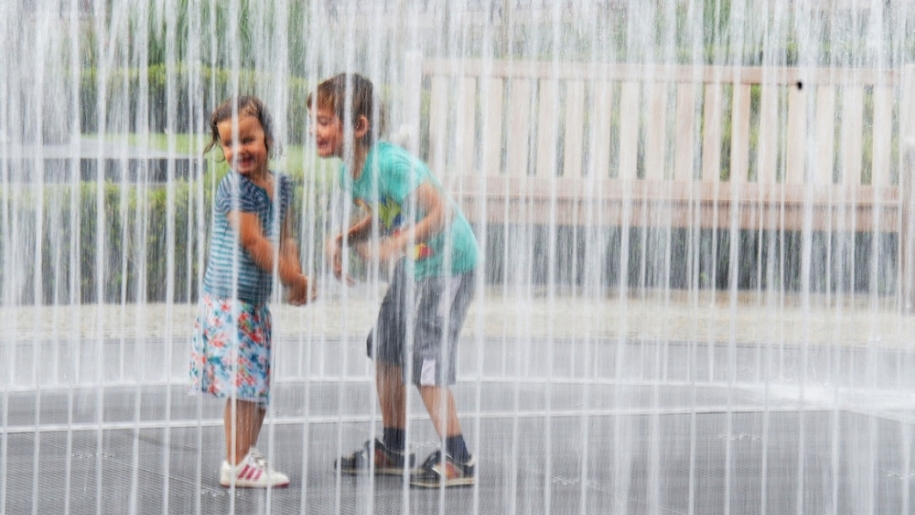 children playing in fountain